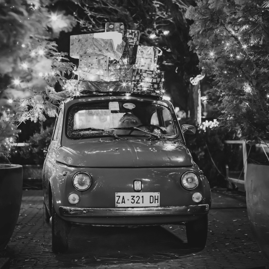 Black-and-white photo of a disco ball with a smaller ornament hanging beneath it, symbolizing festive celebrations, holiday reads, and seasonal book collections.