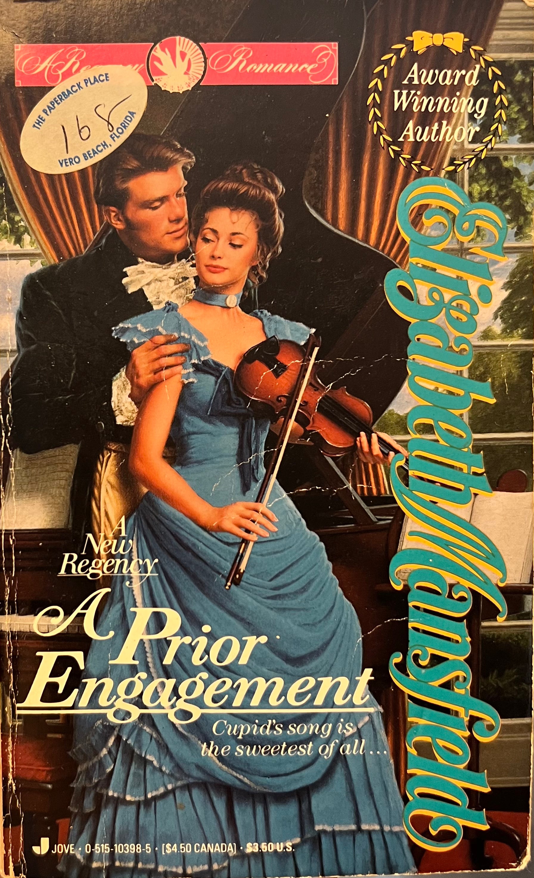 Book cover of 'A Prior Engagement' by Penelope Mansfield featuring a woman in a blue dress holding a violin.