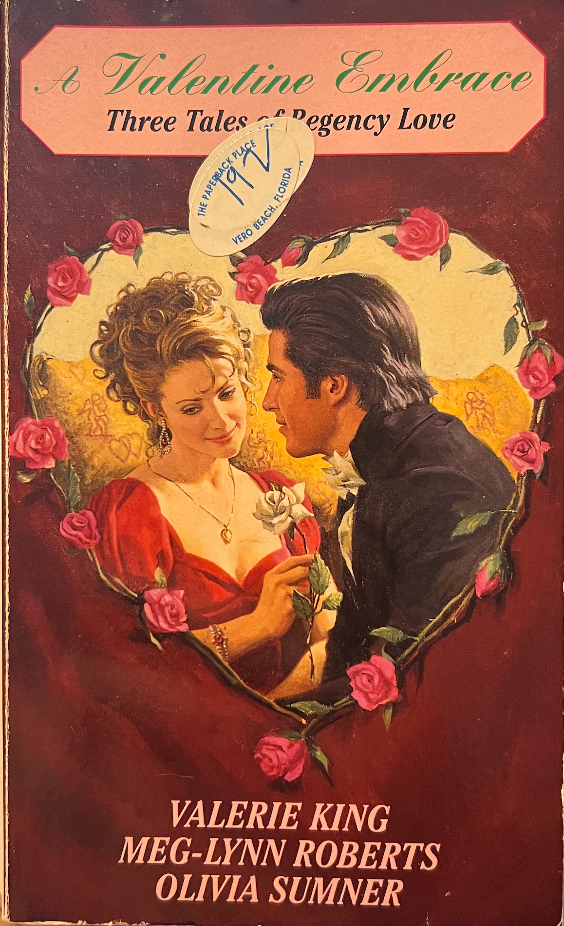 Book cover of 'A Valentine Embrace' featuring a couple and roses.