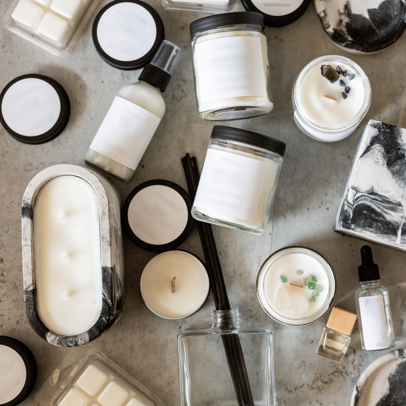 Collection of candles, soap, and other skincare products on a textured surface