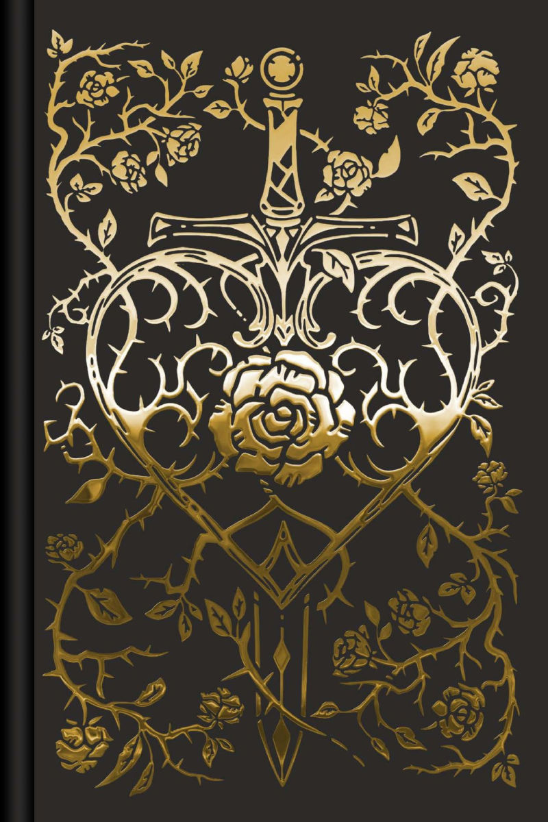 Decorative notebook cover with gold emblem and floral design on black background