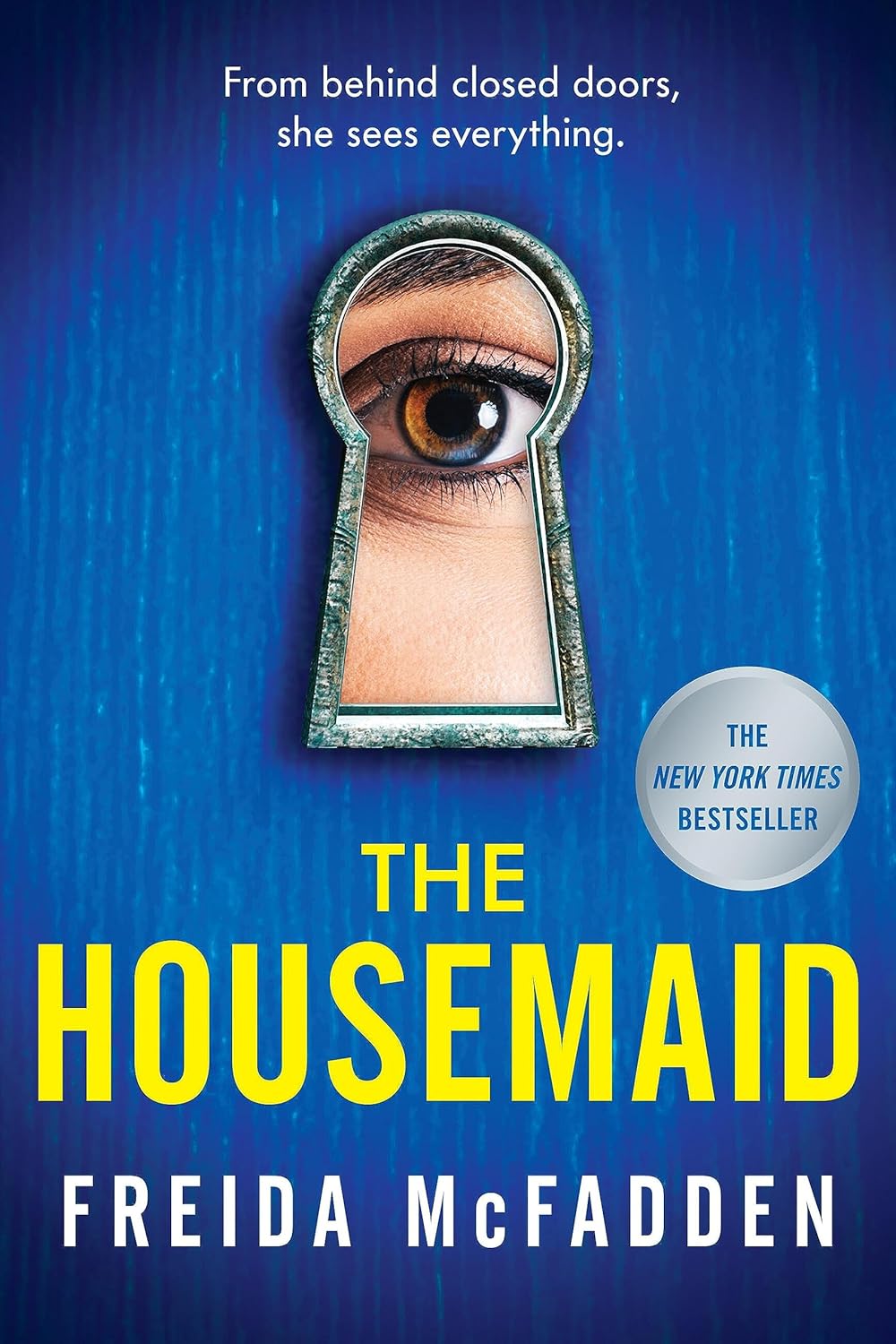 Book cover of 'The Housemaid' by Freida McFadden with a keyhole design and eye illustration.
